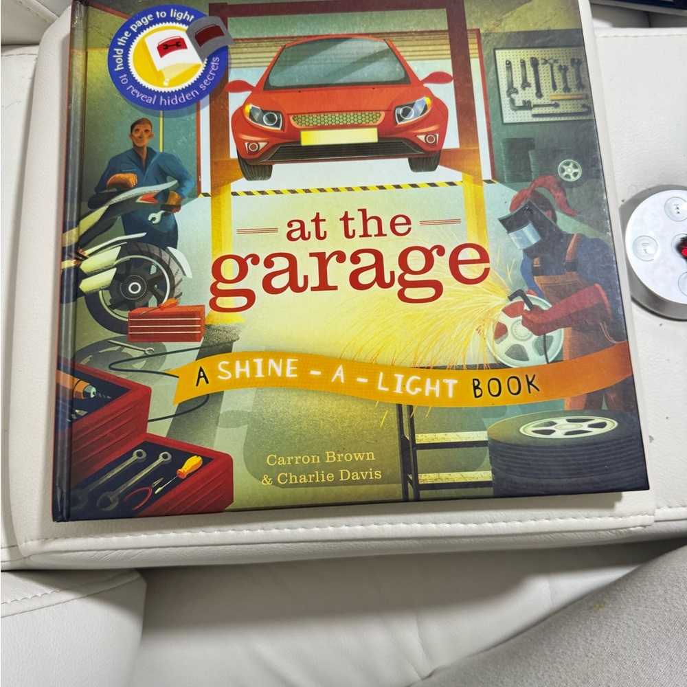At the Garage: A Shine-A-Light Book